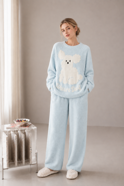 Light blue plush fleece pajama set with a cream puppy motif, ribbed crewneck trim, long sleeves and matching full-length pants.