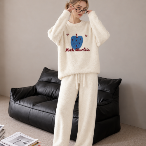 Cream plush fleece pajama set with a blue fruit motif, burgundy lettering, ribbed neckline and sleeve cuffs, and matching full-length drawstring pants.