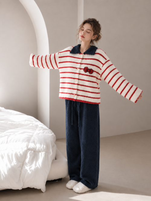 Plush fleece pajama set with a relaxed cream and red striped cardigan, navy collar, front buttons, red bow motif and navy full-length pants.