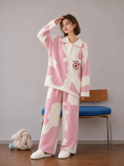 Pink and cream plush fleece pajama set with a cream polo collar, red bear motif on the chest pocket, ribbed sleeve cuffs and matching patterned pants.