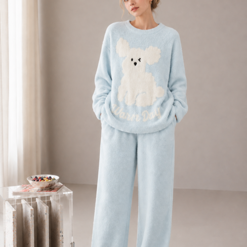 Light blue plush fleece pajama set with a cream puppy motif, ribbed crewneck trim, long sleeves and matching full-length pants.