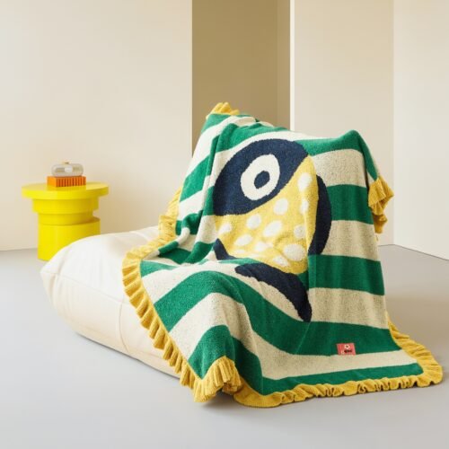 Folded Green & White Striped Half Fleece Knitted Throw Blanket with Spotted Fish Pattern and Yellow Ruffled Border