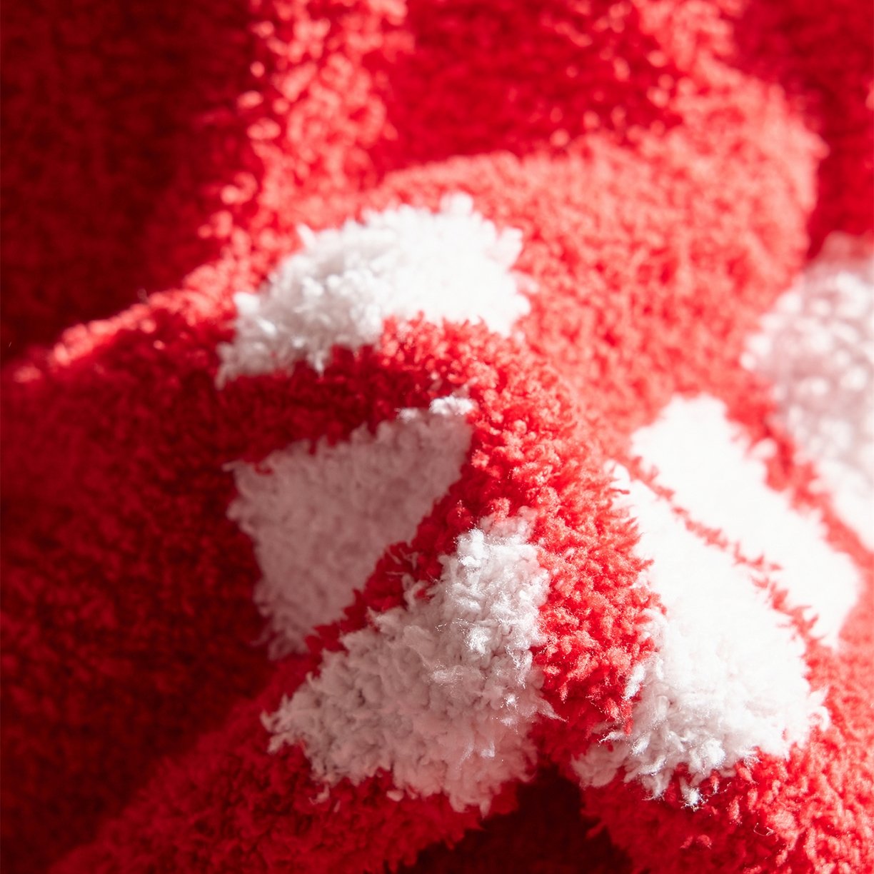 Jacquard Knitted Half Fleece Throw Blanket, Red Base with White Christmas Candy Cane Pattern, Partial Draped View