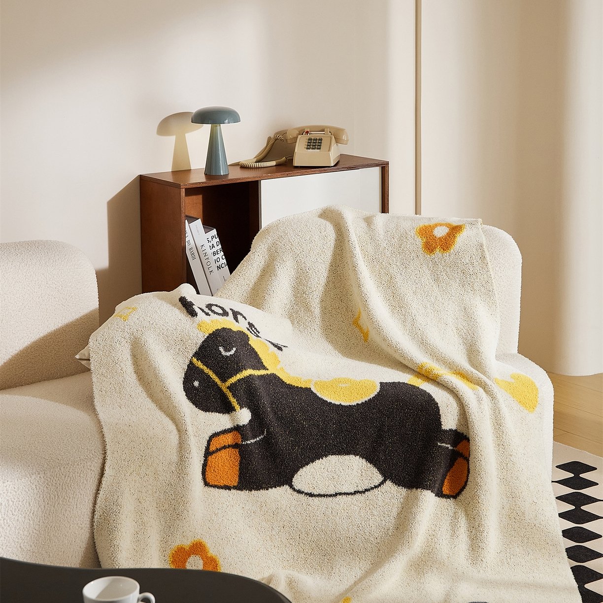 Folded Off-white Half Fleece Knitted Throw Blanket with Cartoon Horse Pattern