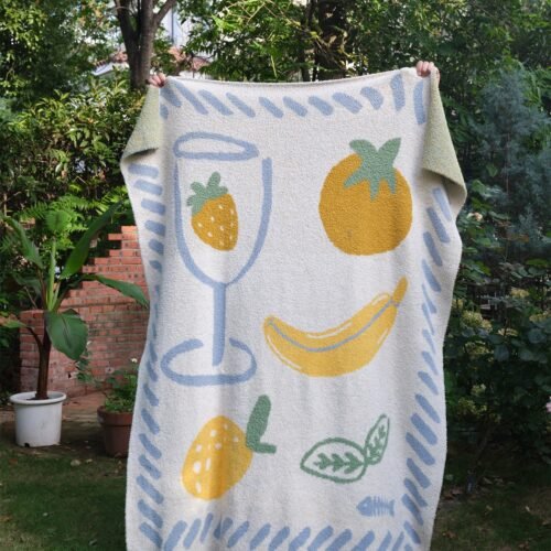 Off-white Half Fleece Knitted Throw Blanket with Fruit Pattern, Draped View