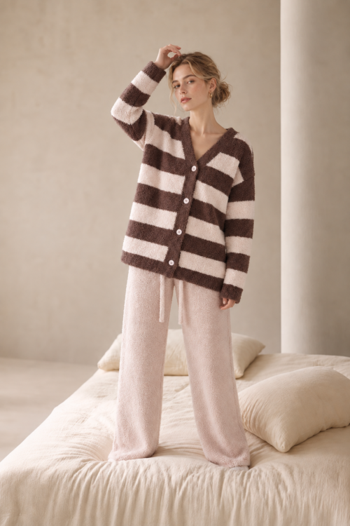 Brown and blush pink plush fleece pajama set with a four-button V-neck cardigan, wide horizontal stripes and solid pink drawstring pants.