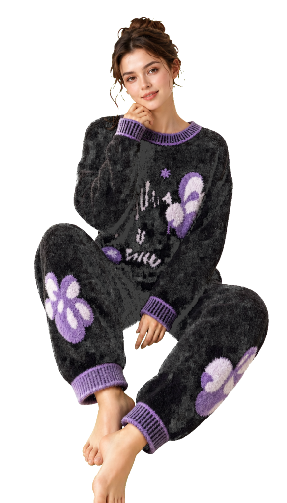 Model wearing a black fleece pajama set with purple floral motifs and ribbed trim.