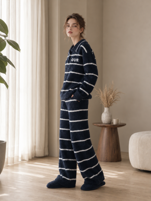 Woman wearing a navy and white striped lapel half fleece pajama set with matching full-length pants, full-body view