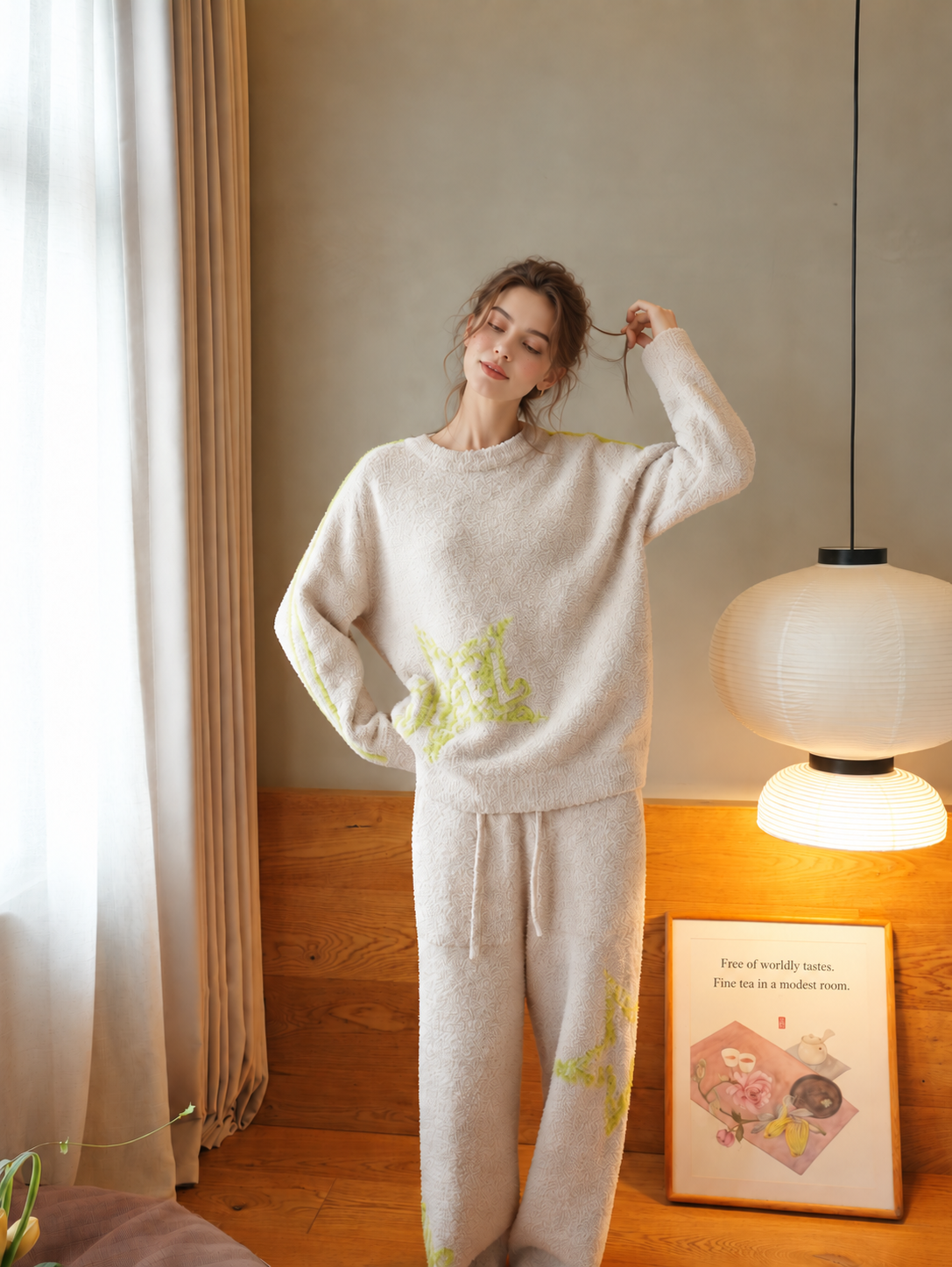 Woman standing in beige graffiti star half fleece pajamas with lime details and full-length pants