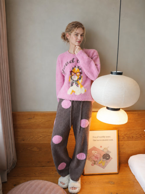 Full-body front view of a woman wearing the YKL8069 pink dog print fleece top and brown polka-dot jogger pants
